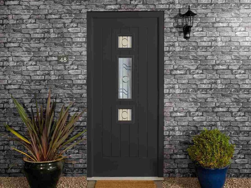 A black composite front door for a home in Dorset.