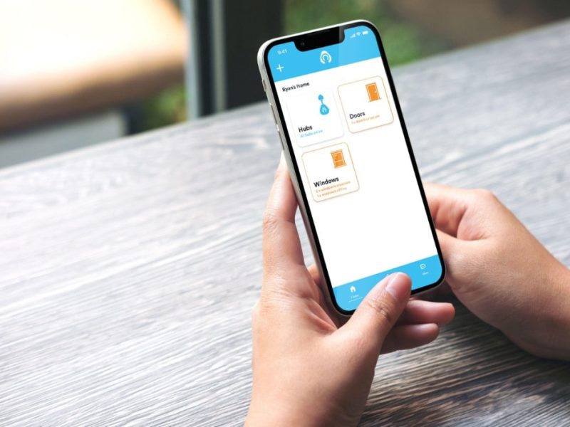 Someone holidng phone open on Kubu smart security app for home security