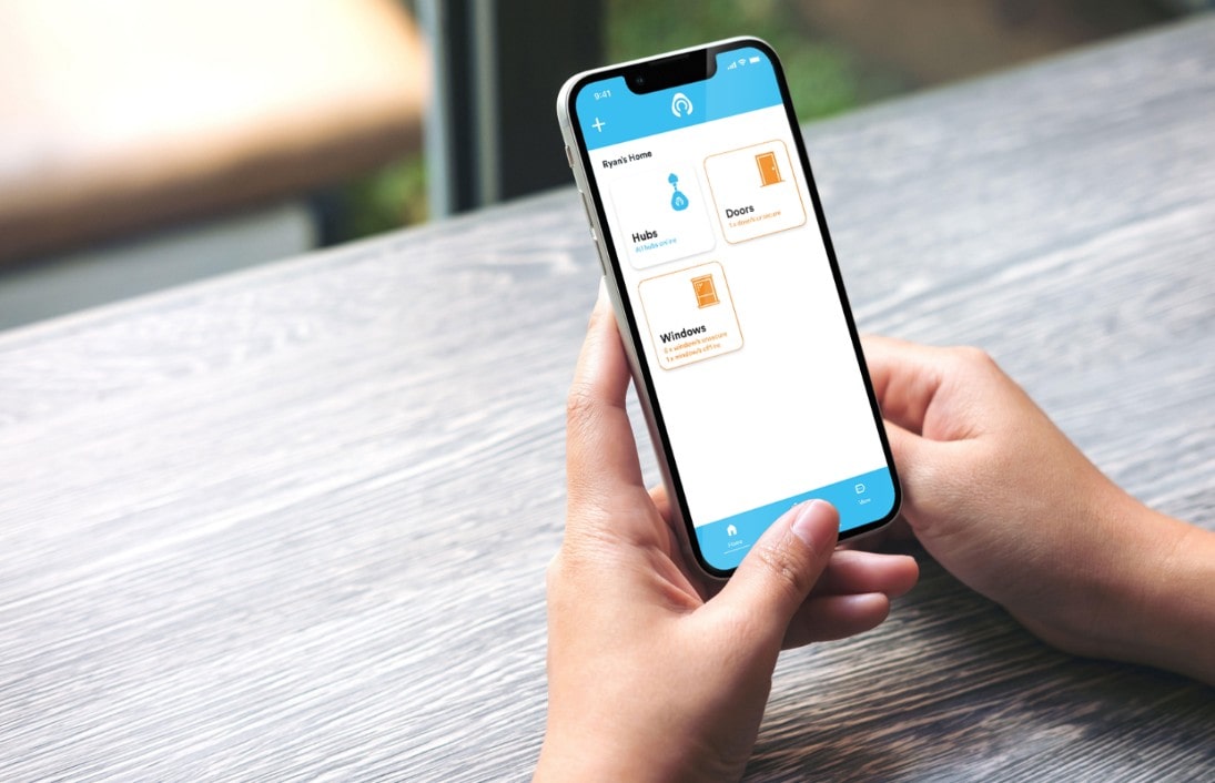 Someone holidng phone open on Kubu smart security app for home security