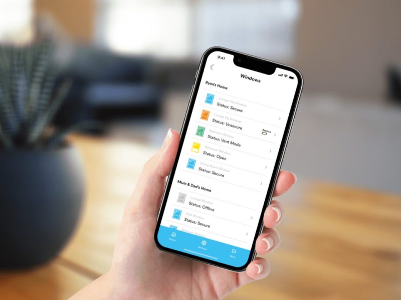 Someone holding a phone with the Kubu smart system app open on secure windows